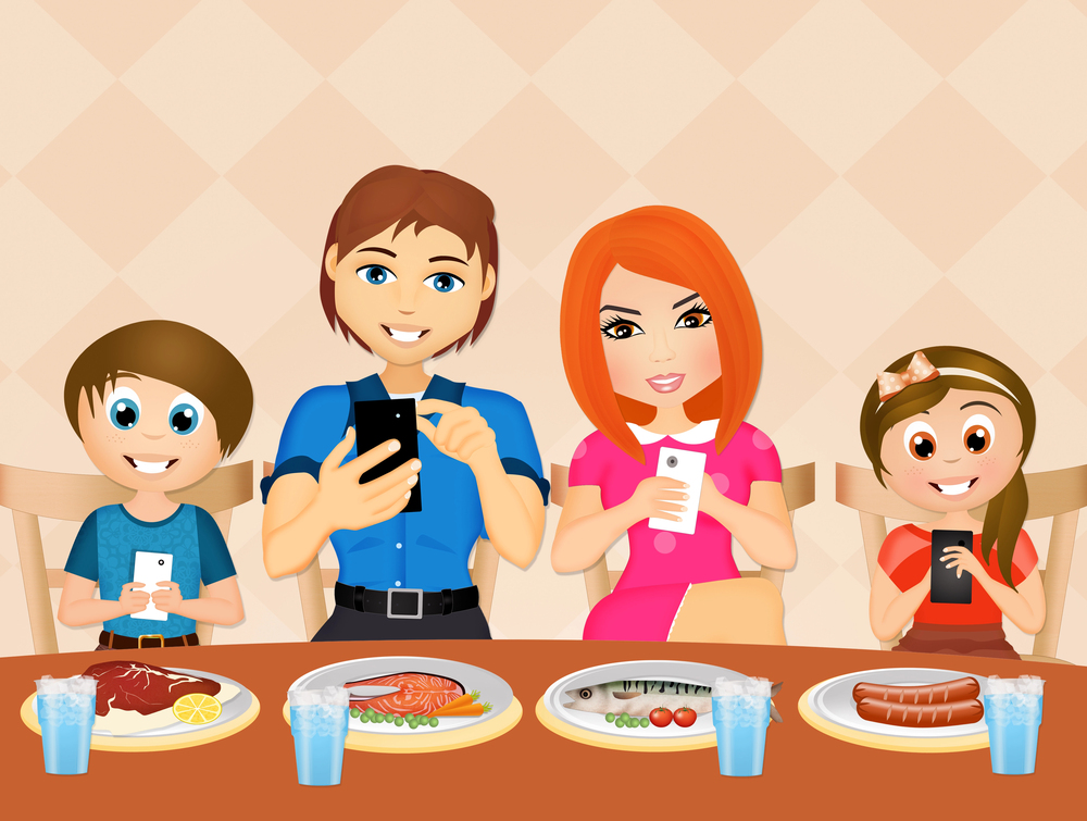 A family of four sits at a dining table with food and drinks, each person focused on their mobile phone instead of interacting with one another.