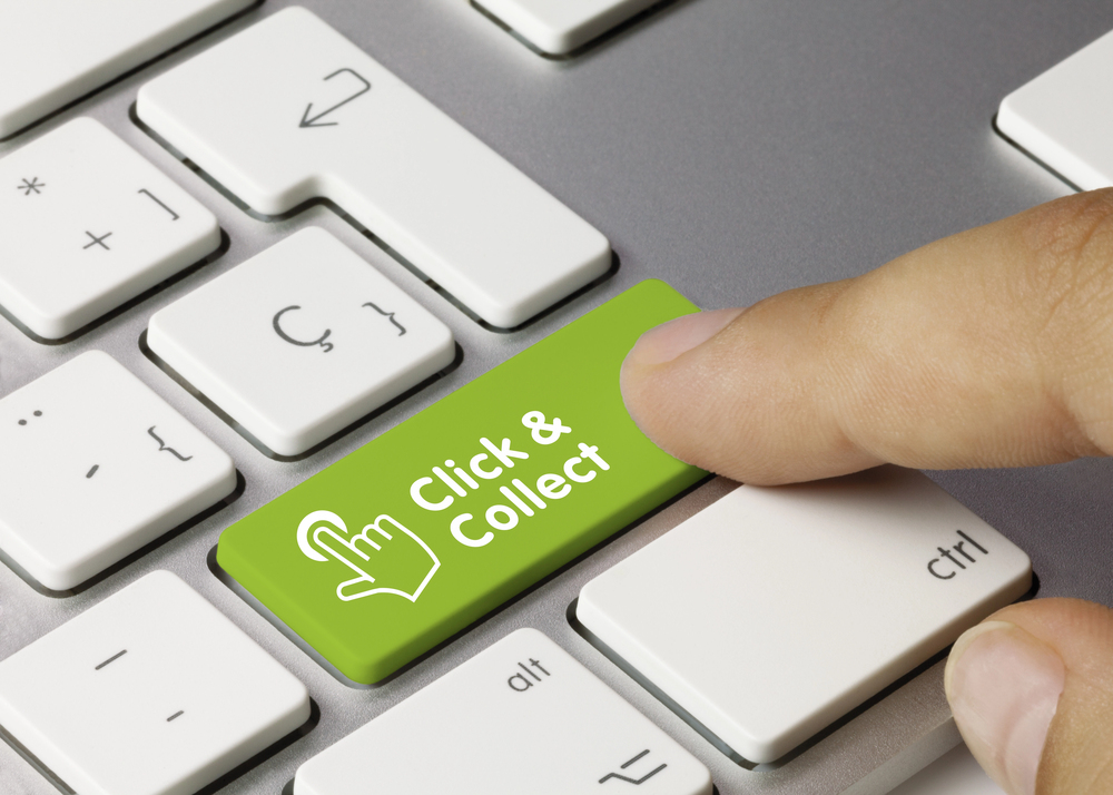 A finger presses a bright green keyboard key labelled “Click & Collect” with a hand icon, surrounded by standard white keys.