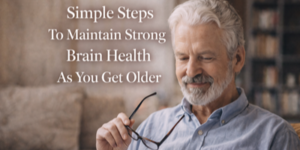 An older man with grey hair and a beard smiles whilst holding his glasses. Text on the image reads: Simple Steps To Maintain Strong Brain Health As You Get Older.