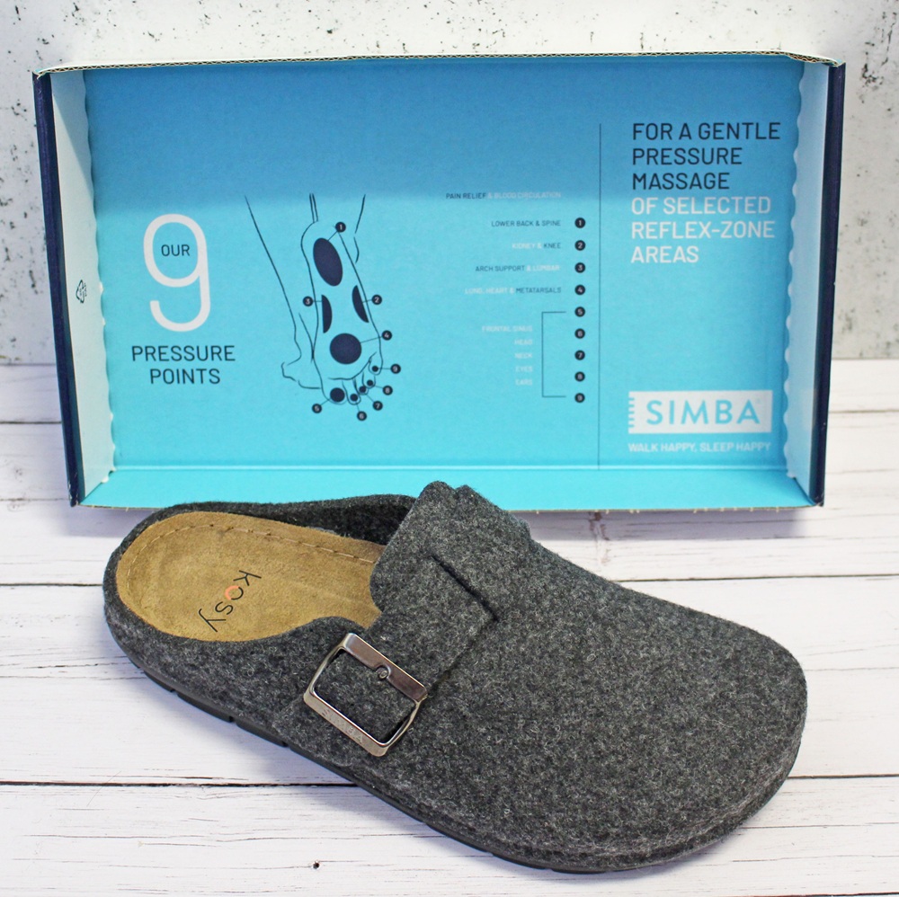 A grey Stormur Slipper with a buckle sits in front of a blue and white box that advertises 9 pressure points for a gentle pressure massage of selected reflex-zone areas. The Simba brand is visible on the box.