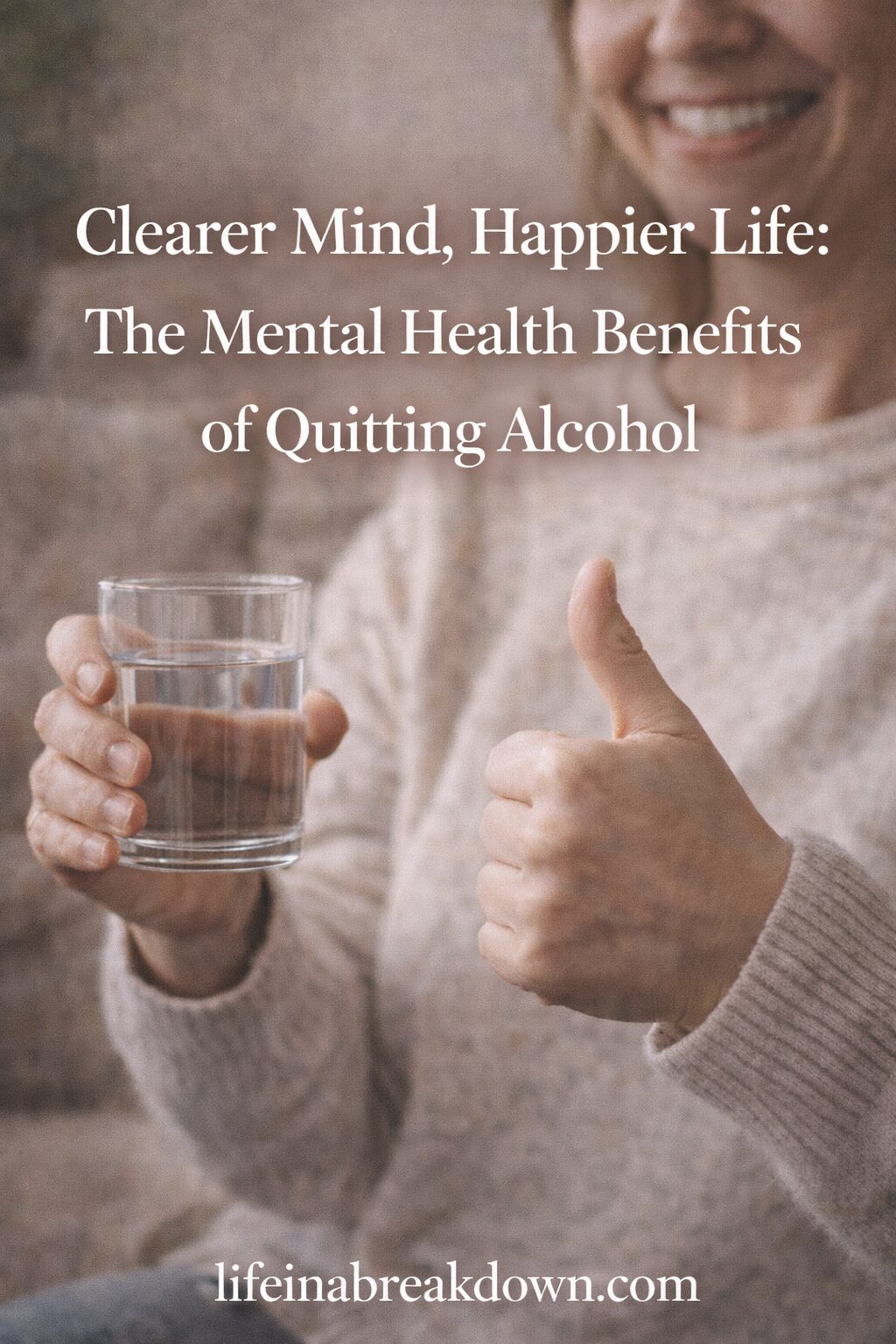 A smiling person in a cosy jumper holds a glass of water in one hand and gives a thumbs-up with the other. Text overlay reads: Clearer Mind, Happier Life: The Mental Health Benefits of Quitting Alcohol.