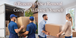 Two removal men in blue uniforms carry a large box from a lorry, while a man and woman handle a box indoors. White text reads, “6 Reasons to Use a Removal Company Vs Doing It Yourself.”.