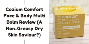 A yellow box of Cozium Comfort Face & Body Multi Balm with Vitamin E is placed on a light wooden surface, next to text that reads: Cozium Comfort Face & Body Multi Balm Review (A Non-Greasy Dry Skin Saviour?).