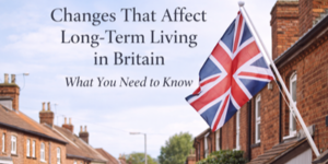 A Union Jack flag hangs outside a brick house on a British street. Text over the image reads, Changes That Affect Long-Term Living in Britain – What You Need to Know.
