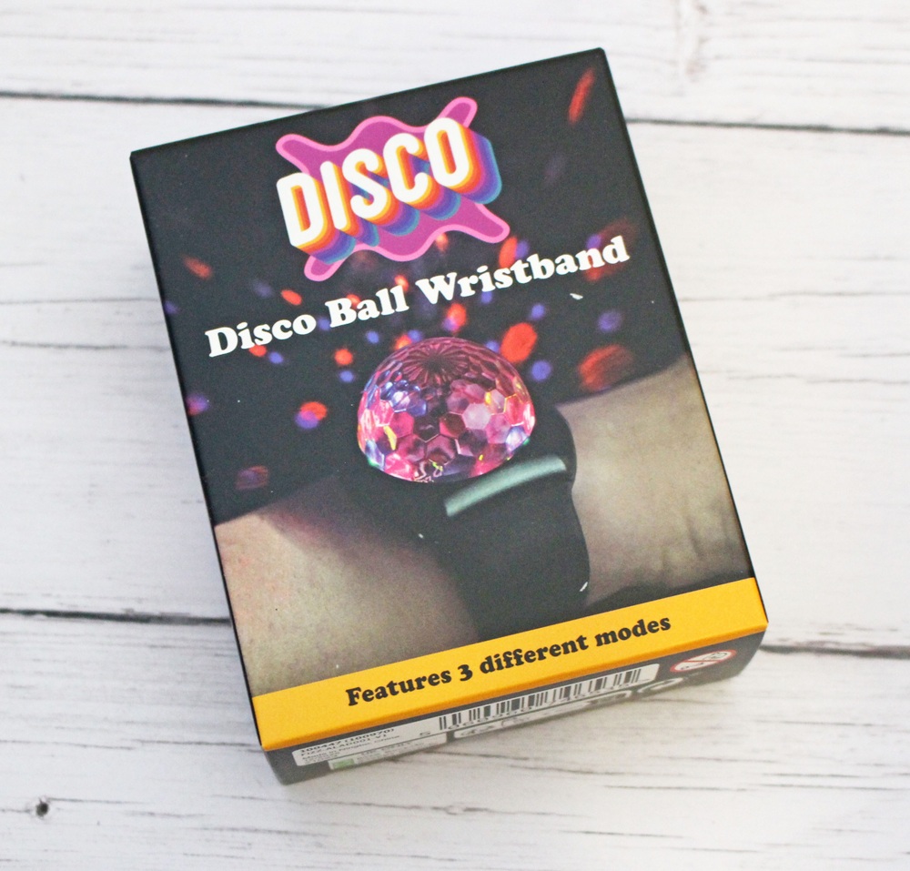 A box labelled Disco Ball Wristband with a photo of a wristband featuring a small disco ball. The packaging says DISCO and Features 3 different modes on a yellow strip at the bottom.