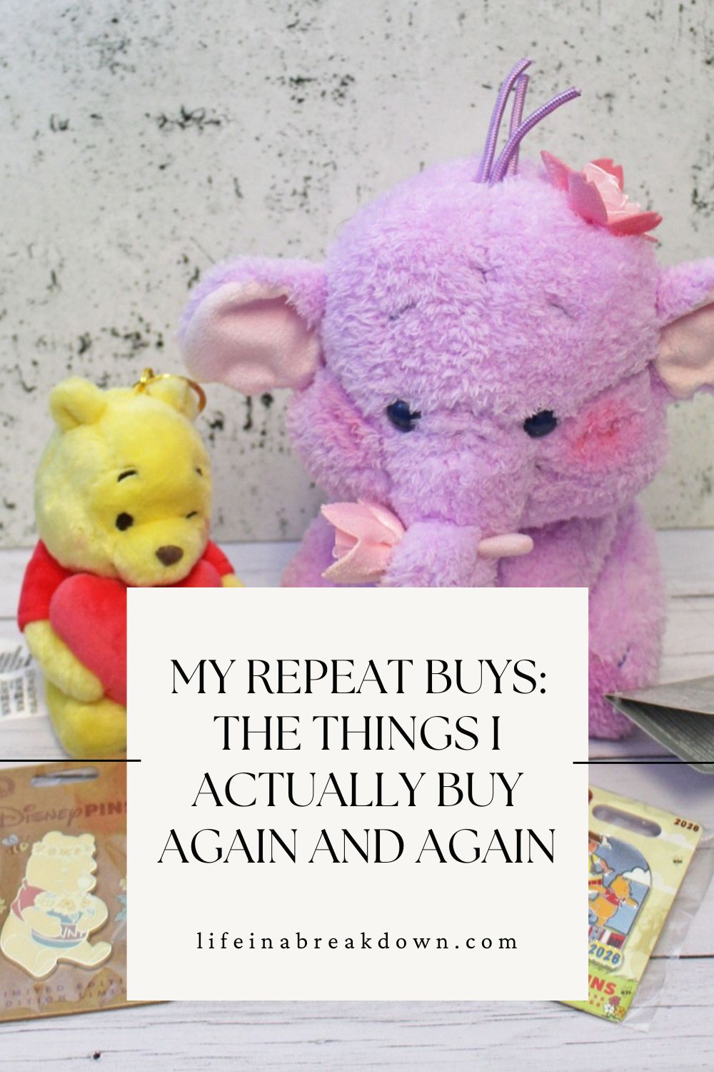 A yellow Winnie the Pooh soft toy and a purple Heffalump soft toy sit together behind a sign that reads, MY REPEAT BUYS: THE THINGS I ACTUALLY BUY AGAIN AND AGAIN lifeinabreakdown.com, with Disney badges—true repeat buys—nearby.