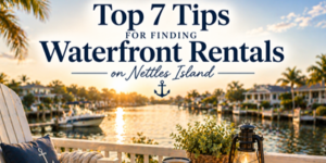 A scenic waterside view at sunset with palm trees, boats, and houses lining the water. Text overlay reads: Top 7 Tips for Finding Waterside Rentals on Nettles Island with a small anchor graphic.