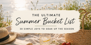 A picnic scene by the water with a straw hat, woven basket, book, glass of lemonade, and flowers. Text reads: The Ultimate Summer Bucket List: 30 Simple Joys to Soak Up the Season.