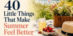 Text reads “40 Little Things That Make Summer Feel Better.” Beside the text is a picnic scene with a basket of wildflowers, a jar of lemonade, fresh strawberries, and a straw hat on a chequered blanket.