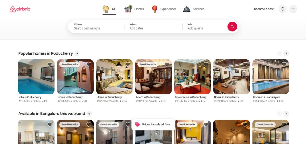 Screenshot of Airbnb’s website showing popular homes in Puducherry and available homes in Bengaluru. Listings feature images, prices per night, guest ratings, and labels like Guest favourite or Prices include all fees.