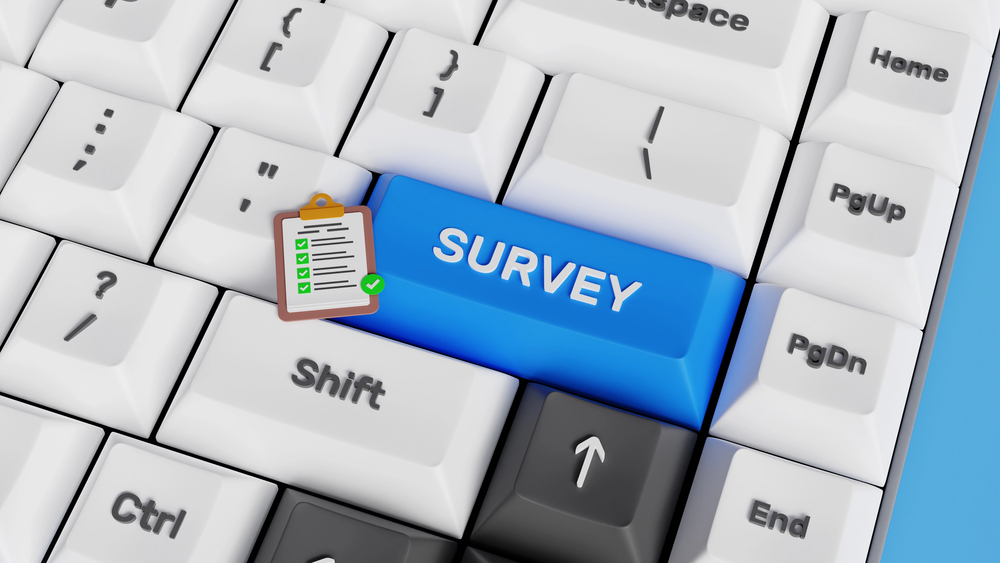 A computer keyboard with a large blue Survey key, a white clipboard icon on it, and the Shift key nearby.