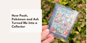 A hand holds a Pokémon card in a plastic sleeve. Text on a white box reads, How Pooh, Pokémon and Ash Turned Me Into a Collector. Background shows greenery and flowers.