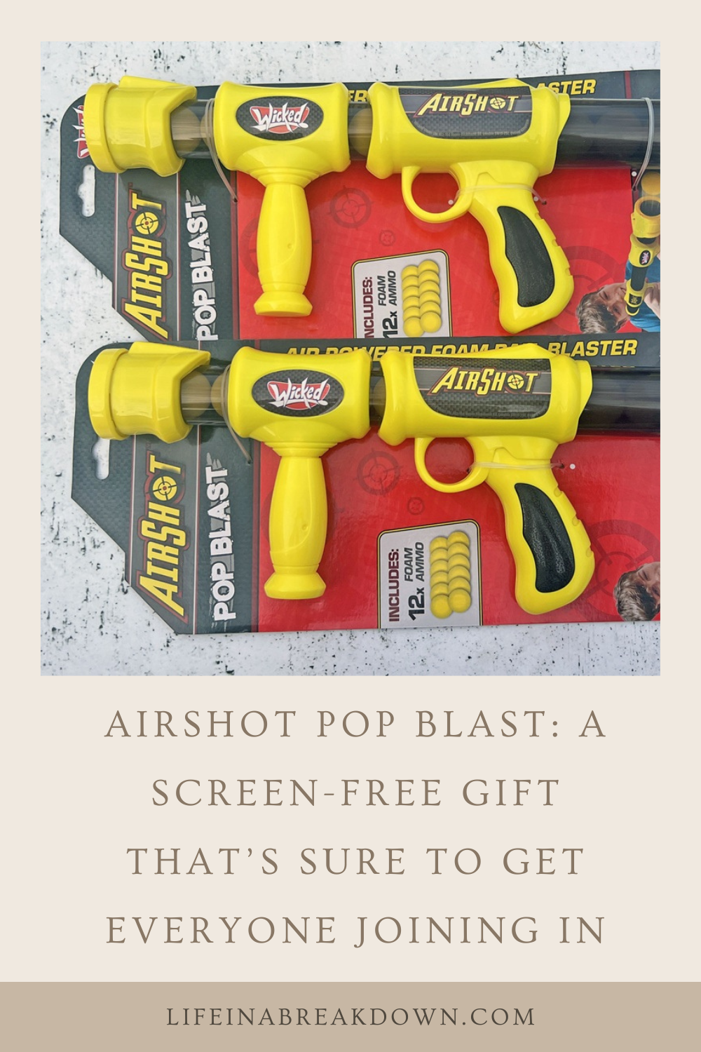 Two yellow and black Airshot Pop Blast toy guns in packaging are shown on a table. A beige banner below reads, Airshot Pop Blast: A screen-free gift that’s sure to get everyone joining in..
