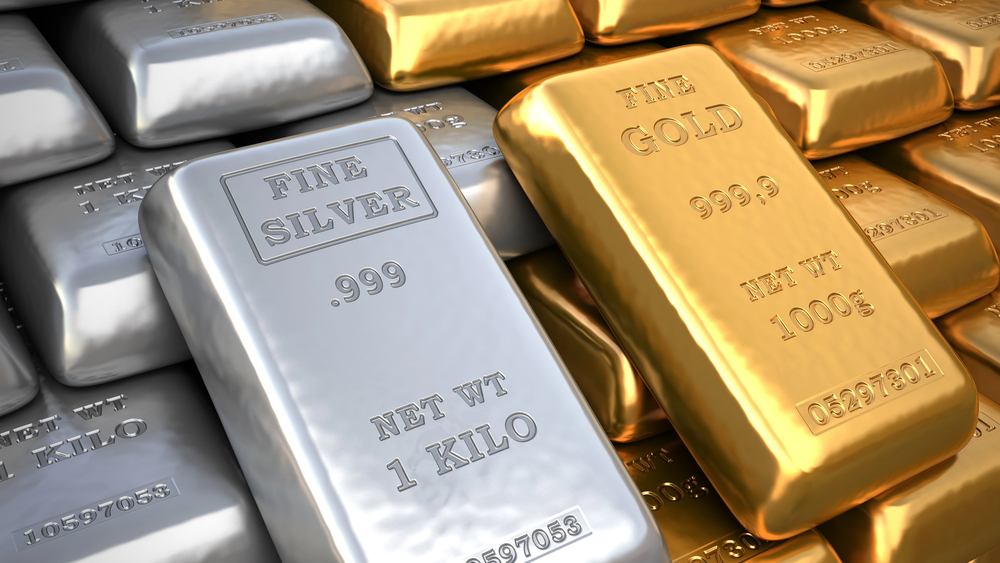 Stacks of gold and silver bars, with inscriptions showing their purity and weight. A close-up view highlights a silver bar marked .999 Fine Silver 1 Kilo and a gold bar marked 999.9 Fine Gold 1000g.