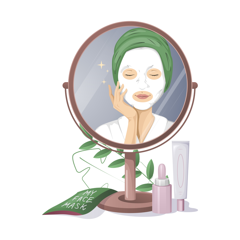 A woman with a green hair towel applies a white face mask whilst looking in a mirror. Skincare products and a face mask packet are on the table. Green leaves are visible around the mirror.