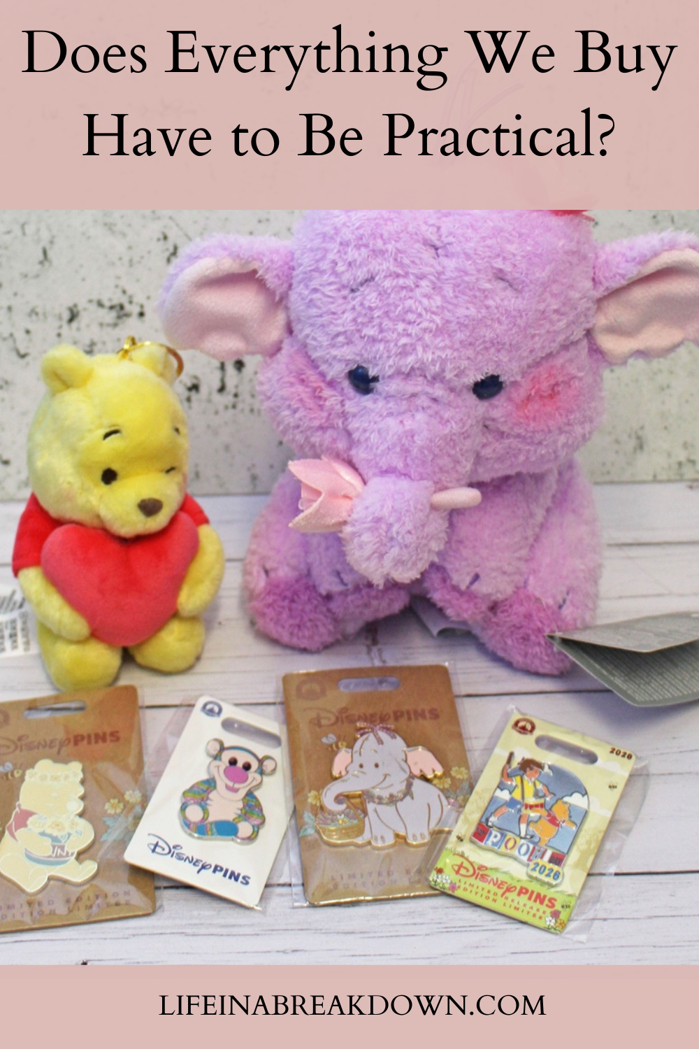 A small Winnie the Pooh soft toy, a larger purple Heffalump soft toy, and four Disney collector badges are displayed on a table. Text above reads, Does Everything We Buy Have to Be Practical?.