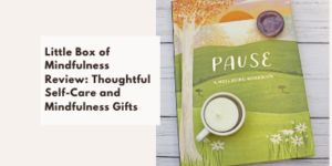 A workbook titled Pause lies on a wooden surface with a candle and small bowl on top. Next to it, text reads: Little Box of Mindfulness Review: Thoughtful Self-Care and Mindfulness Gifts.