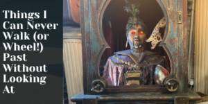 A fortune teller automaton with glowing red eyes sits in an ornate booth. Text on the left reads, Things I Can Never Walk (or Wheel!) Past Without Looking At..