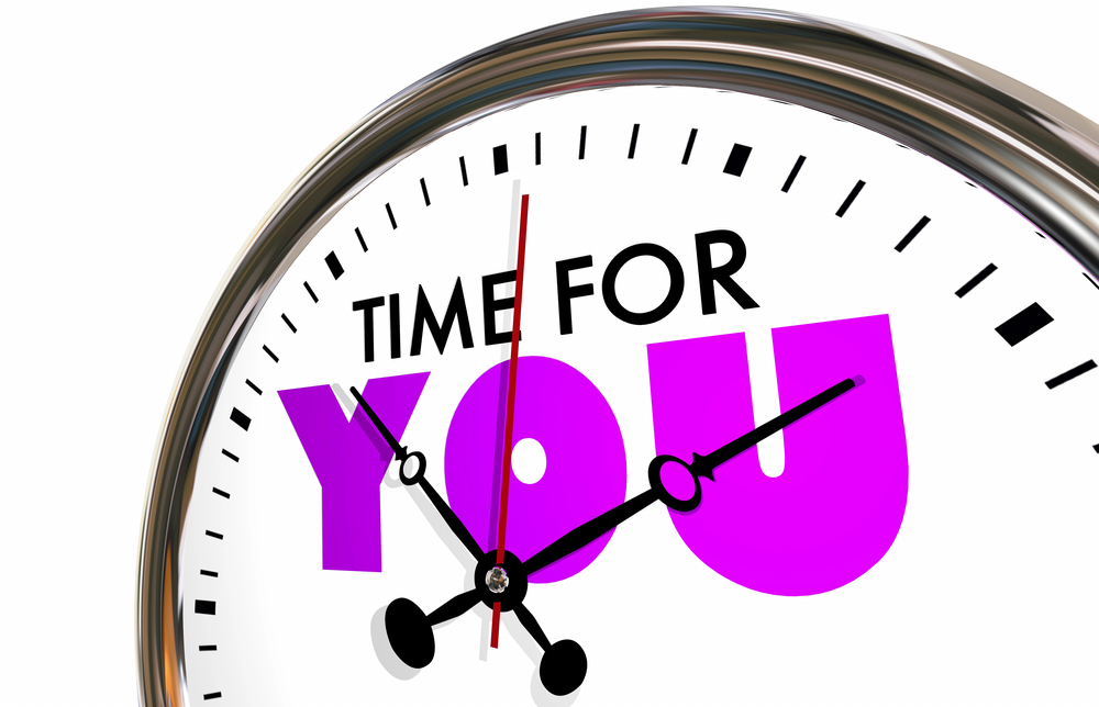 Close-up of a clock face with the text TIME FOR YOU on the dial.