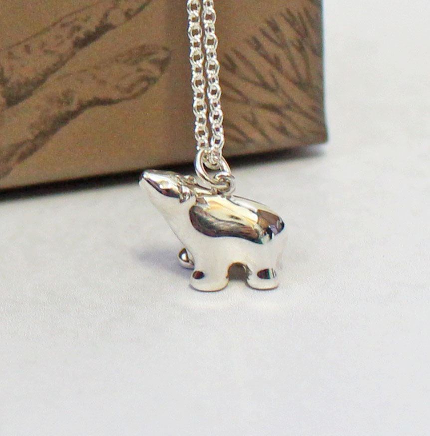 A silver polar bear pendant on a delicate chain.
