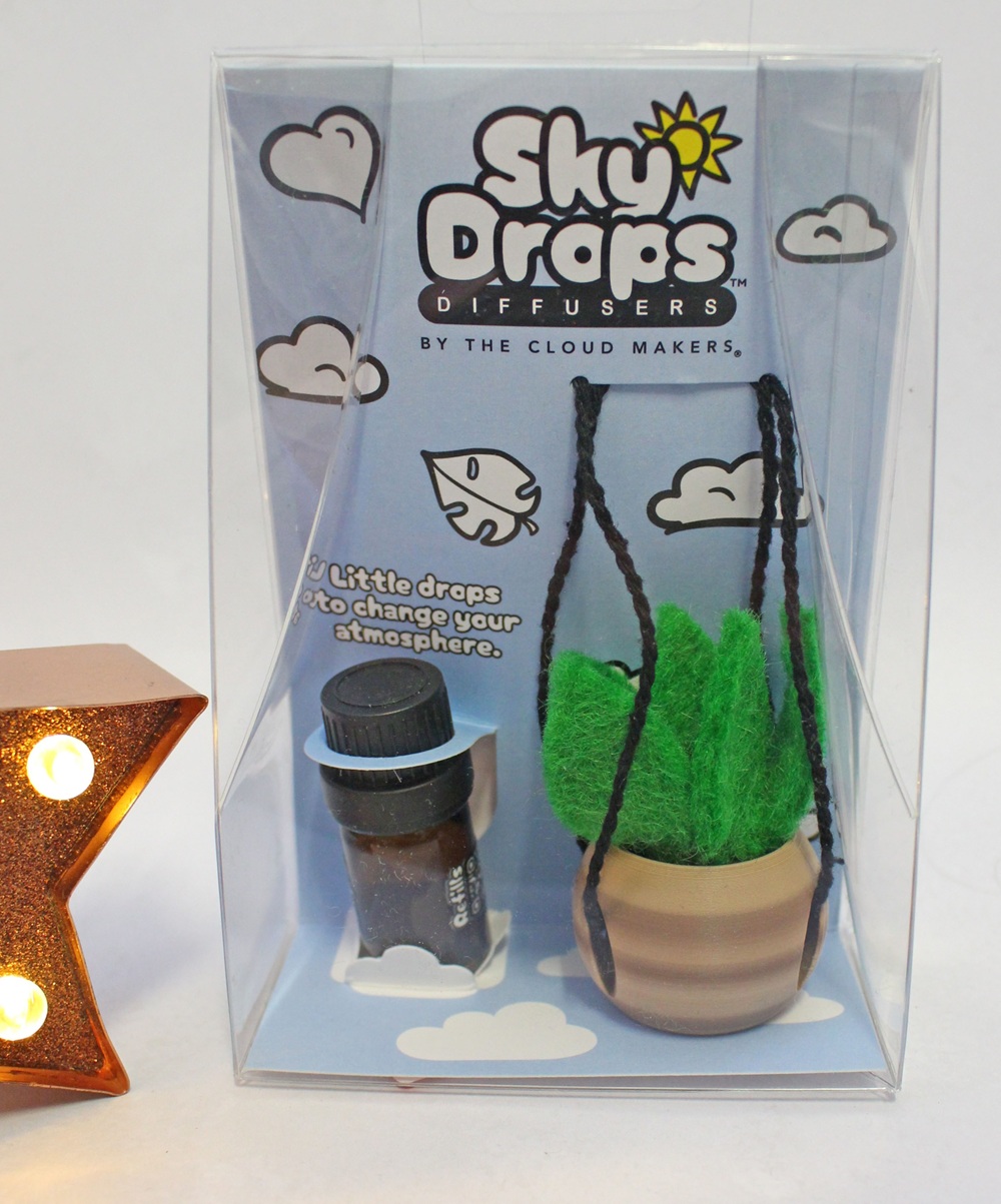 Sky Drops diffuser kit in a clear box, containing a small bottle of oil and a miniature hanging felt plant.