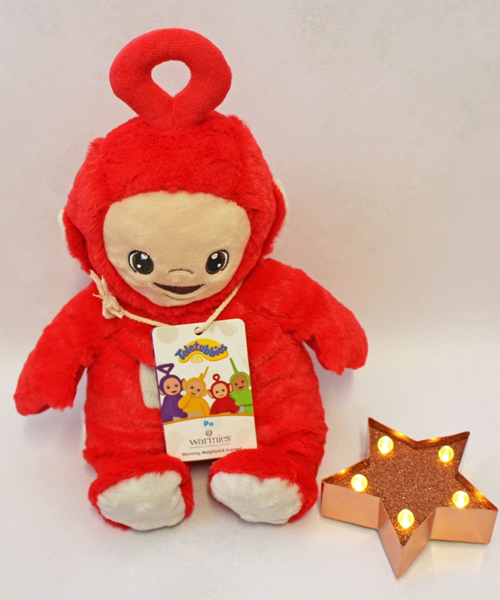 Red Po Teletubbies soft toy with a product tag and a light-up star ornament.
