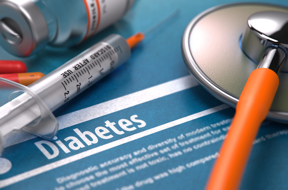 A medical document titled Diabetes with a syringe, vials, pills, and a stethoscope placed on top.